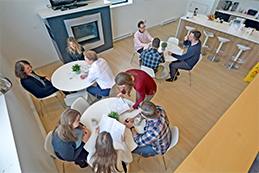 Employees in a group setting talking